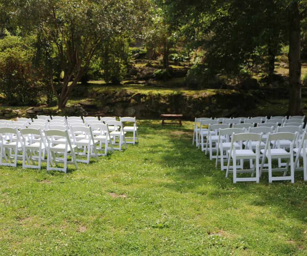 Riverside lawn set with chairs for an outdoor gathering