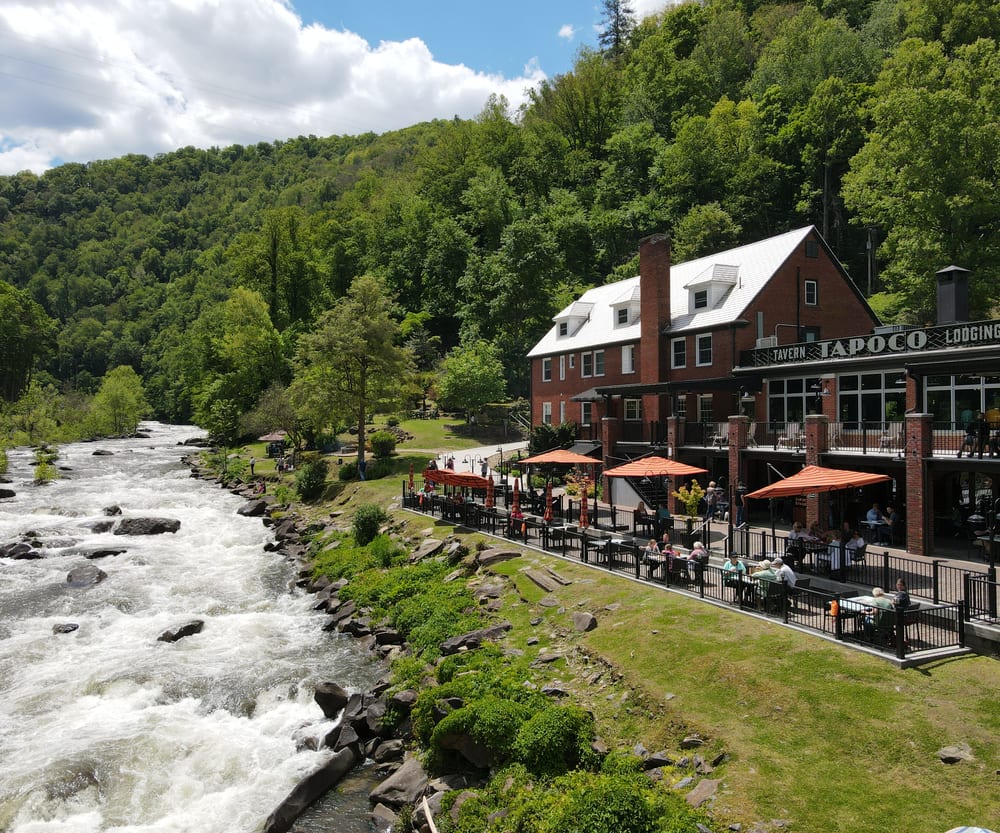Guests dining on the riverside terrace above the Cheoah