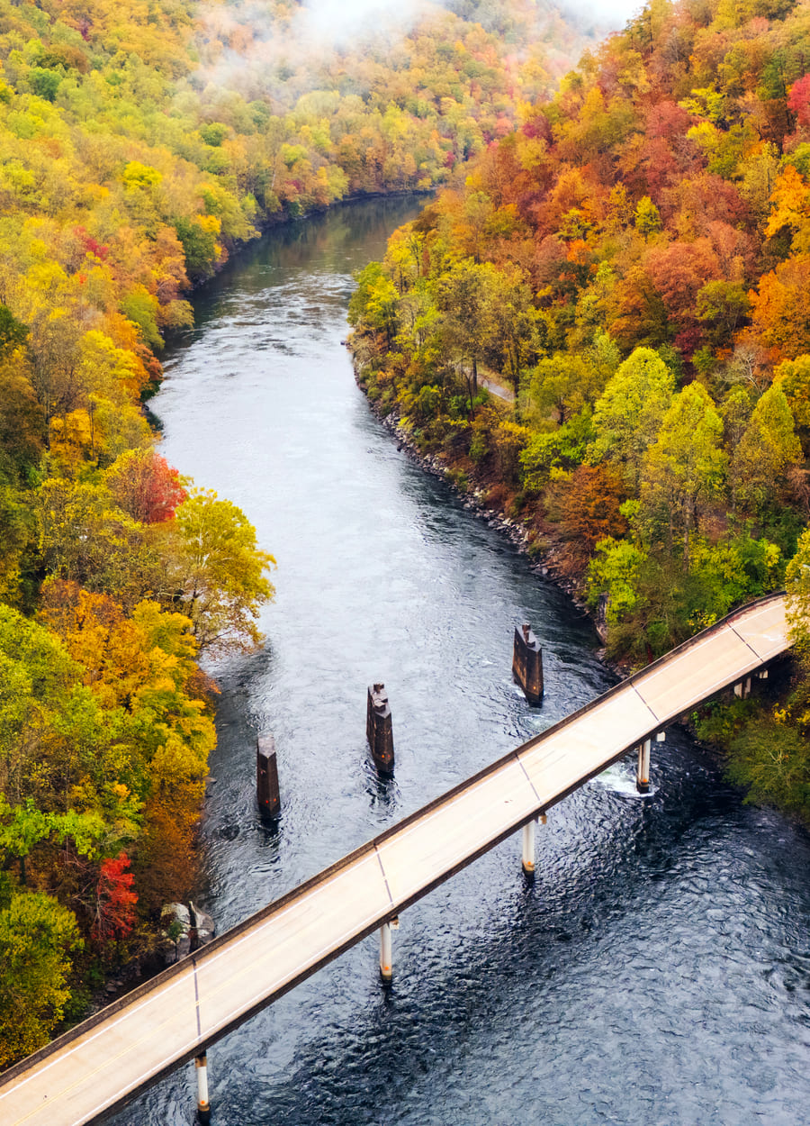 A highway bridge crossing the Cheoah River gorge in autumn